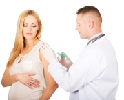Pregnant woman getting vaccine from her gynecologist
