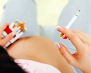 View from above of a pregnant woman with cigarette.