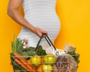 Pregnant Woman Carrying Healthy Groceries --- Image by Â© Corbis